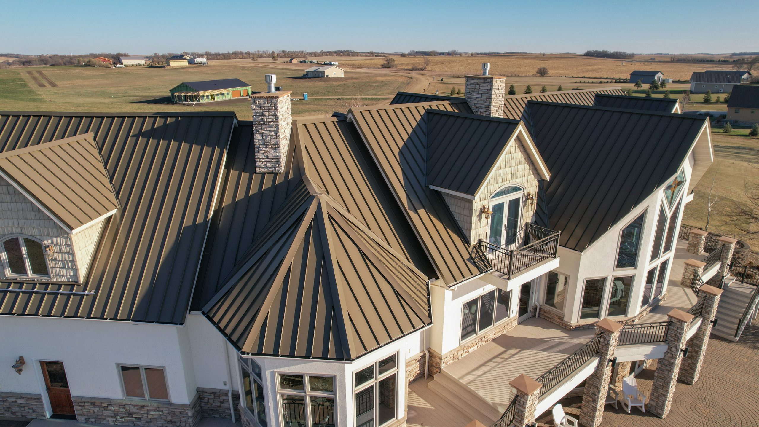 This home has standing seam metal roofing installed by Spotless & Seamless Exteriors.